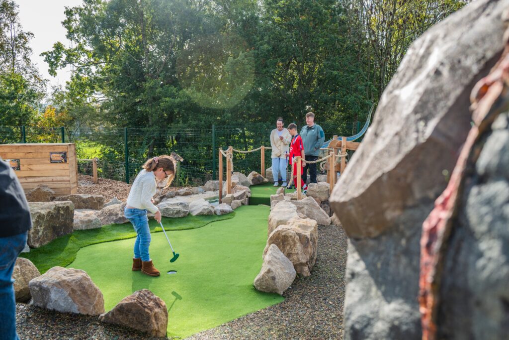 Family playing adventure golf in Burnley