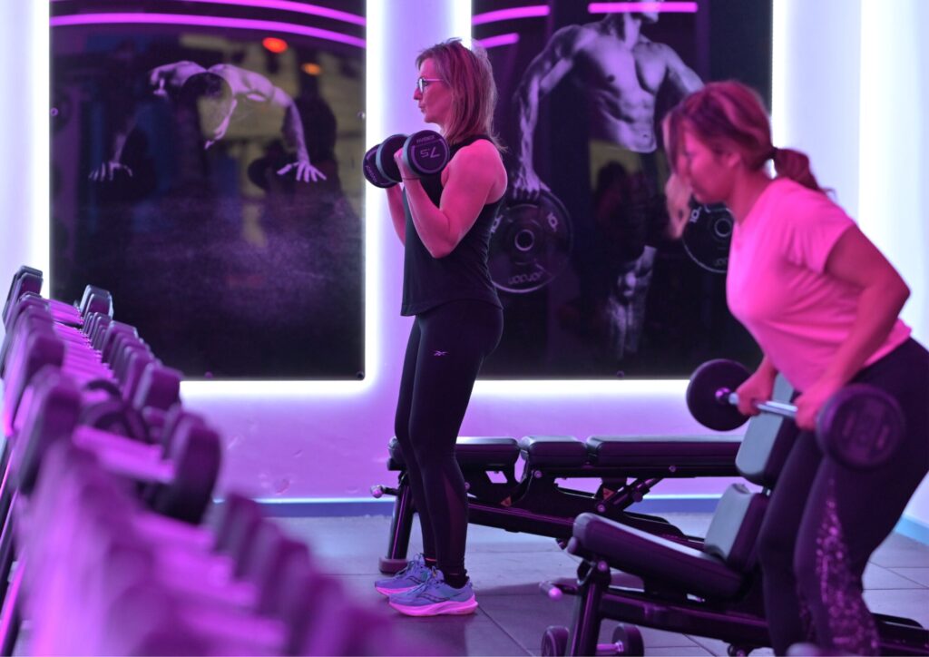 Two girls with free weights doing exercise