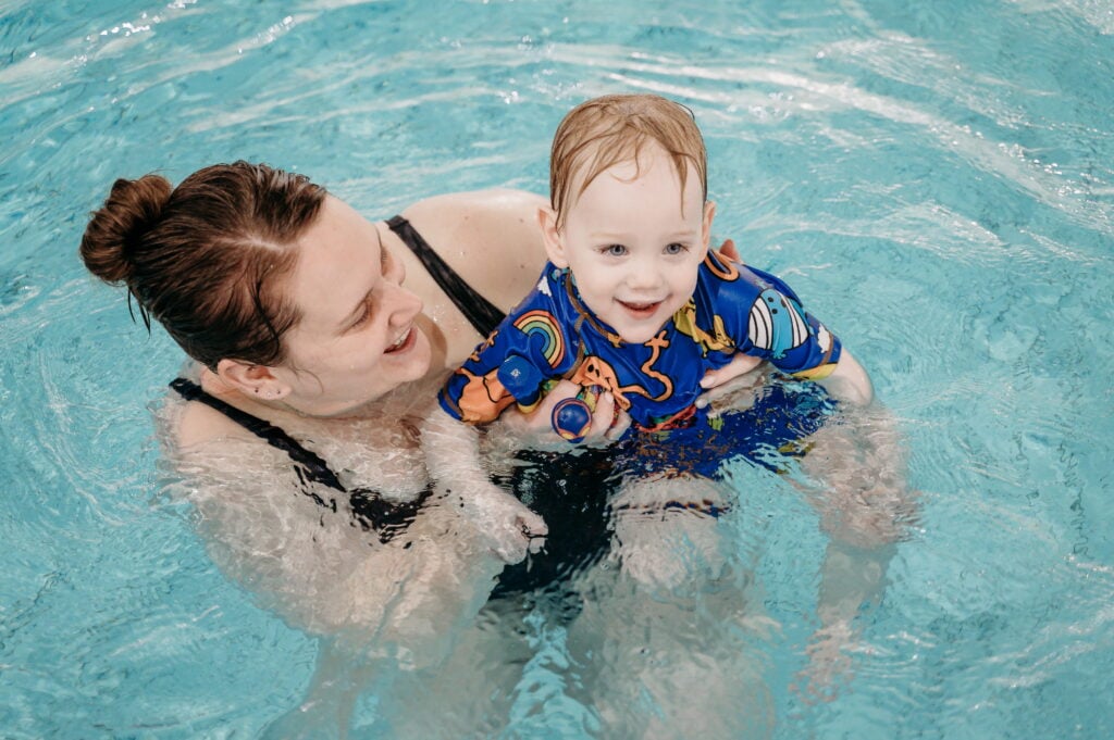 Mother and child swimming together