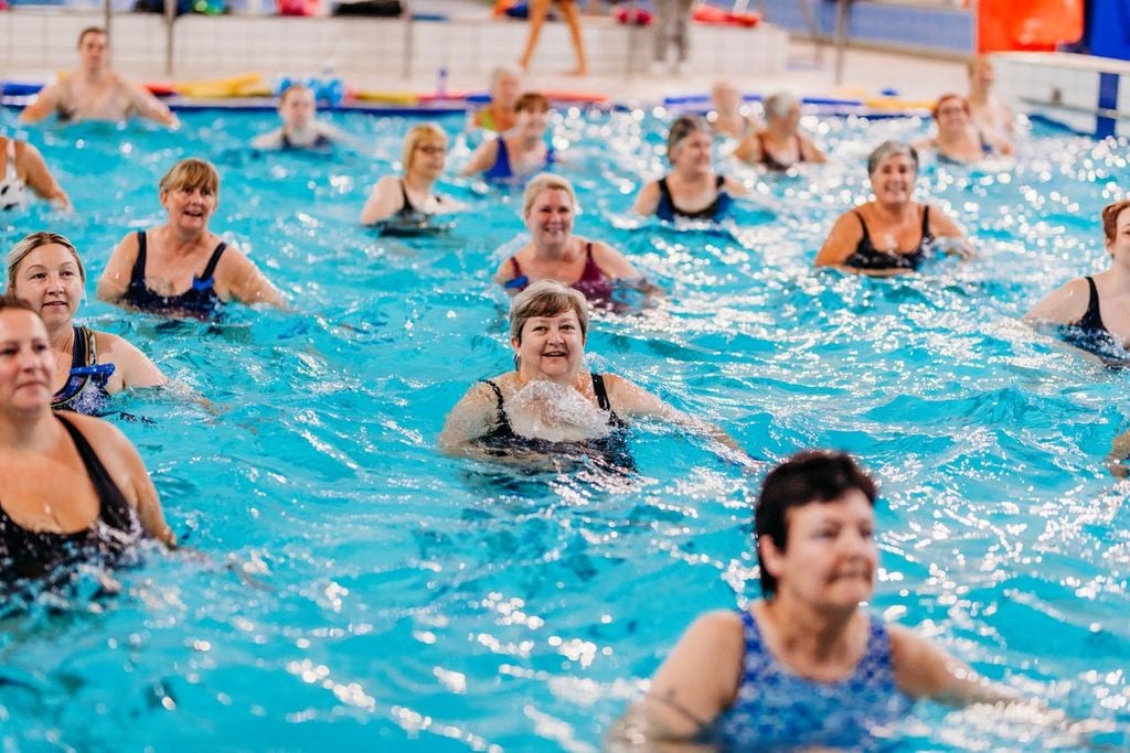 Happy woman doing swimming exercies