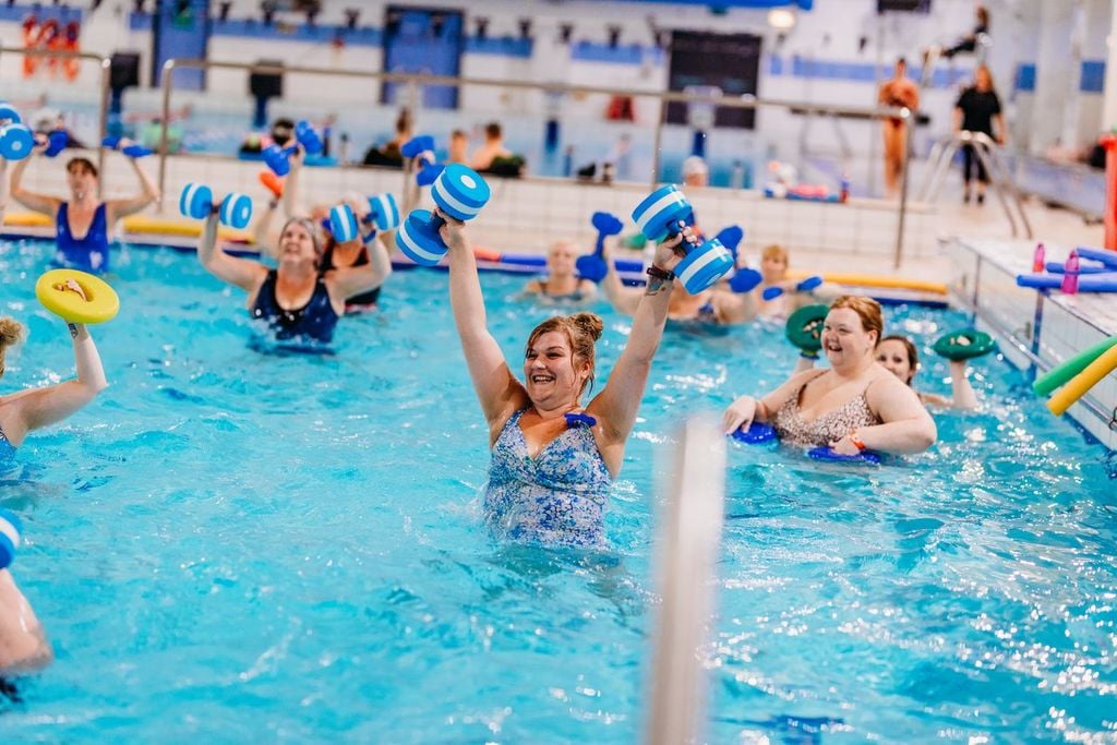 Happy people exercising in the pool