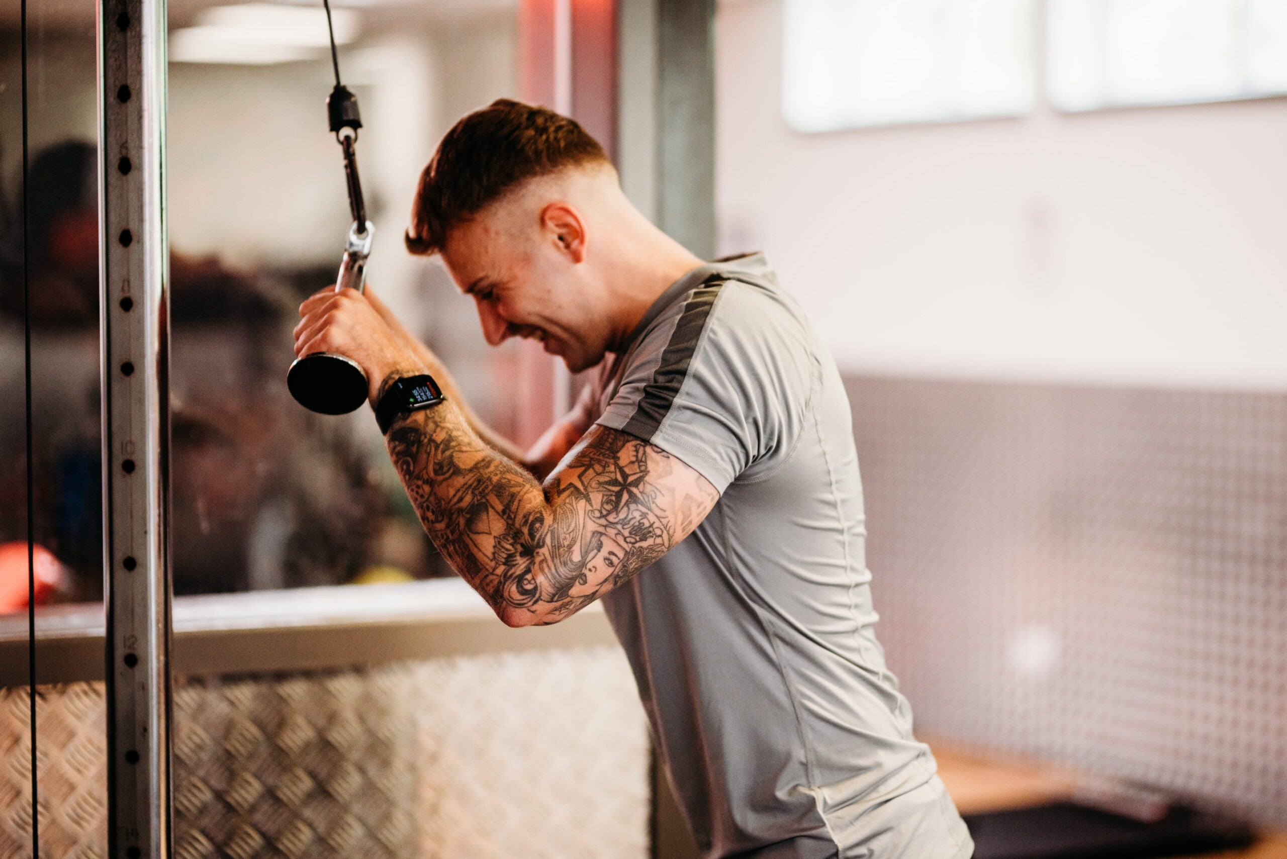 A man performs a resistance band exercise during a weight training session.