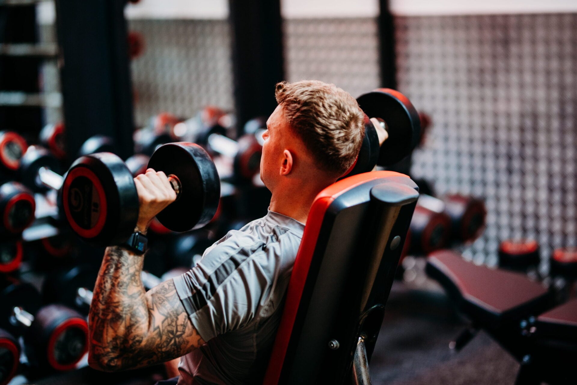 Personal training help man lift weights