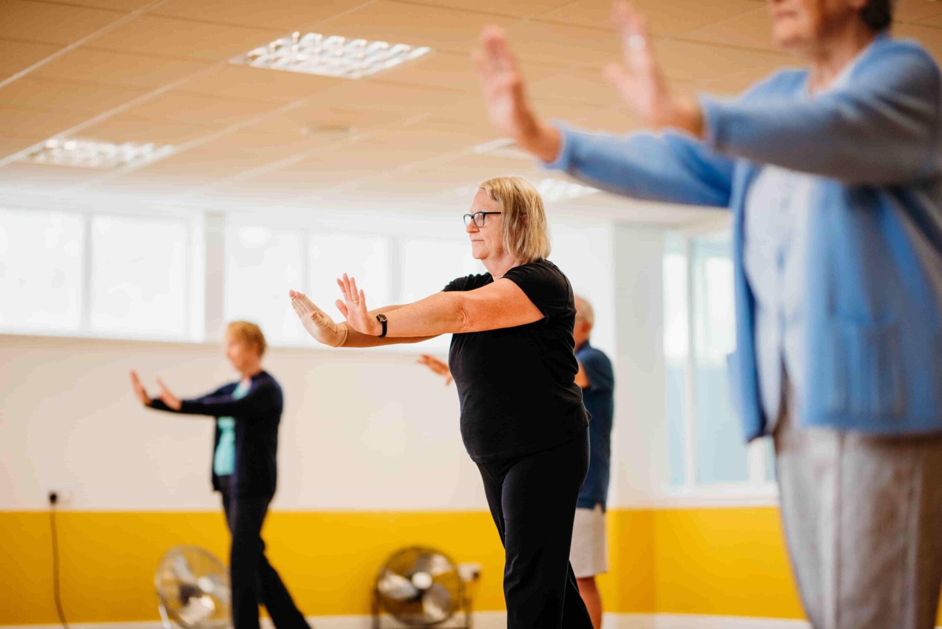 Class members move through choreography during a group fitness session.