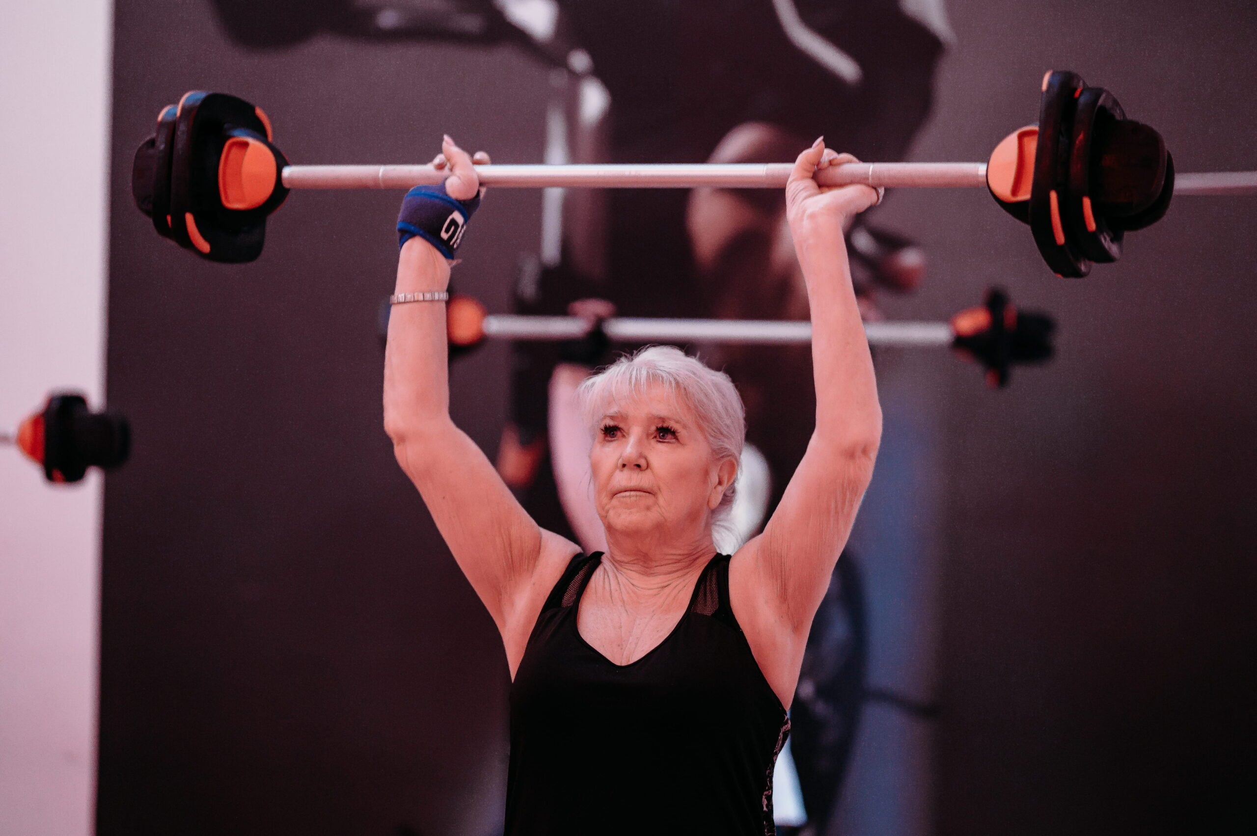 Woman in a gym class lifting weights