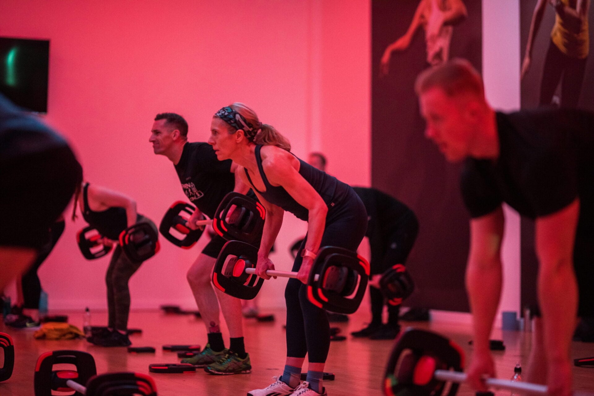 Participants use resistance equipment during a group workout session.