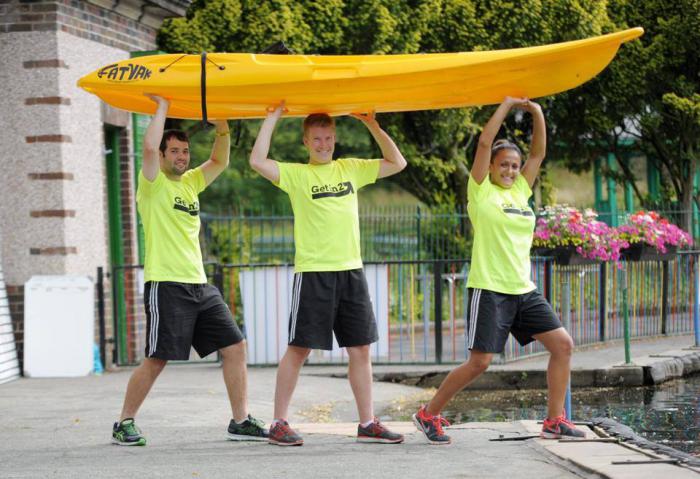 The Boathouse - young people carrying a canoes