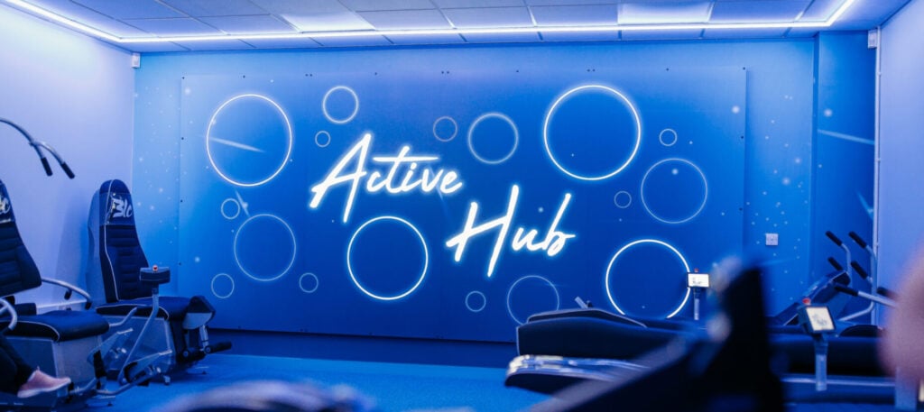 An illuminated "Active Hub" sign displayed on a blue background.