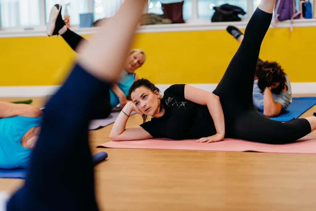 Woman doing leg raises in a gym class