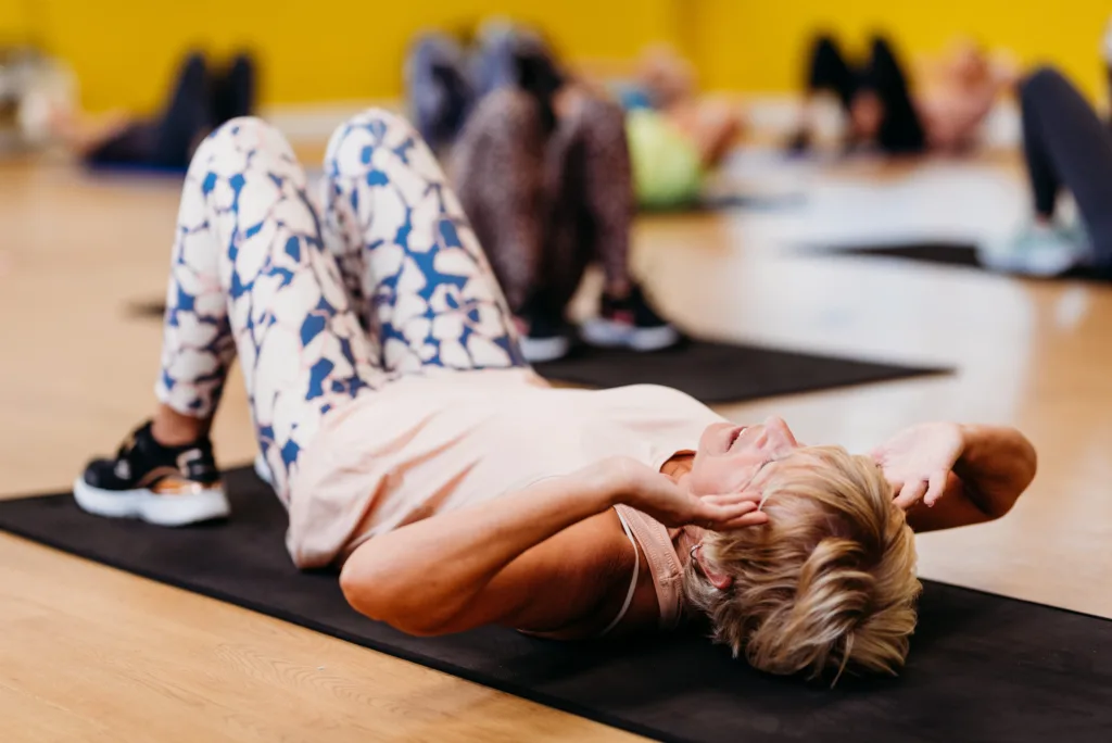 Lady doing a leg, bums and tums exercise