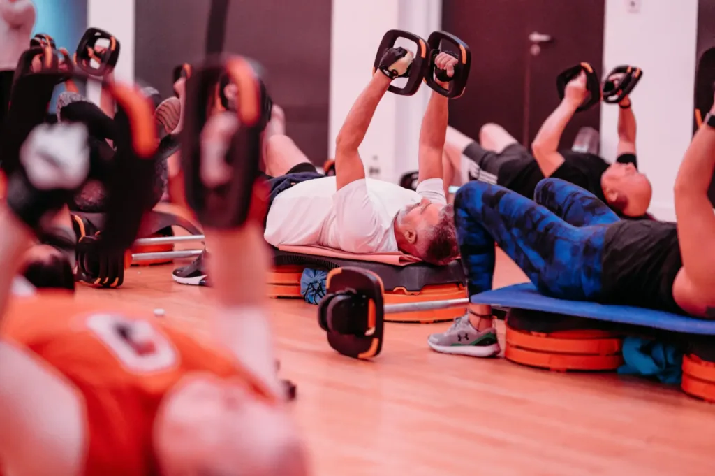 Men doing lying down weights