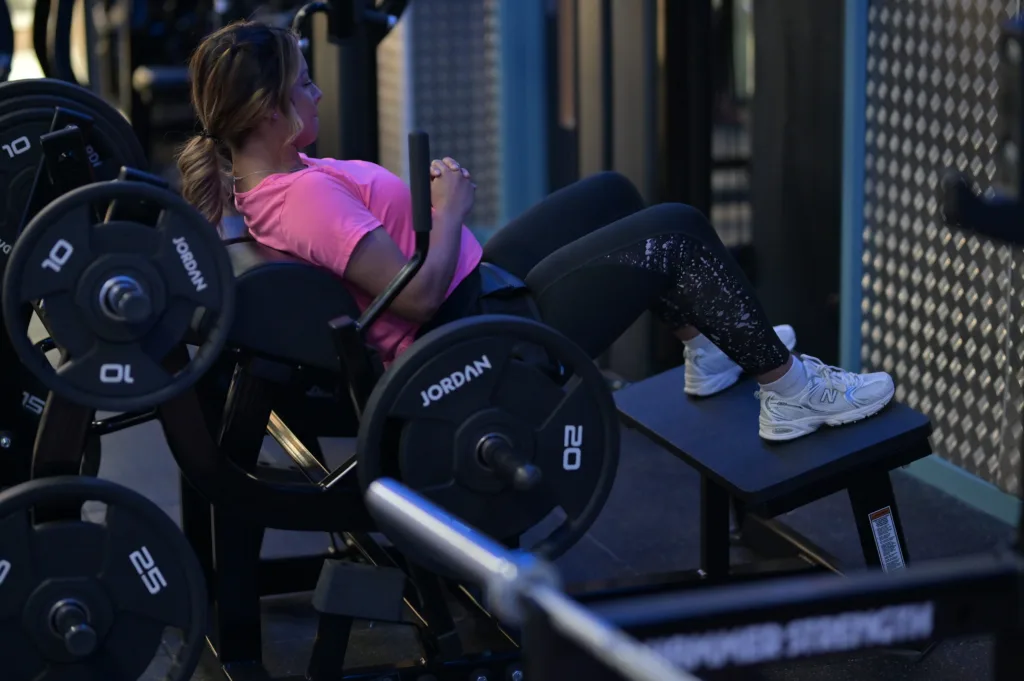 Woman doing leg press in the gym