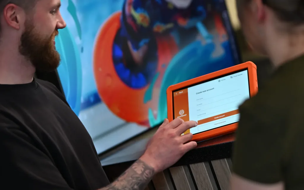 Good Boost instructor showing customer result on a tablet