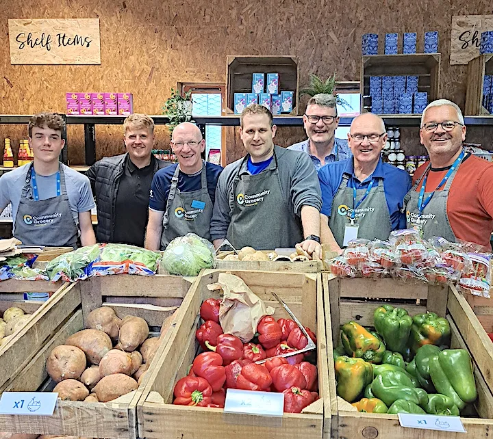 Group of volunteers working at the community café to donate surplus food