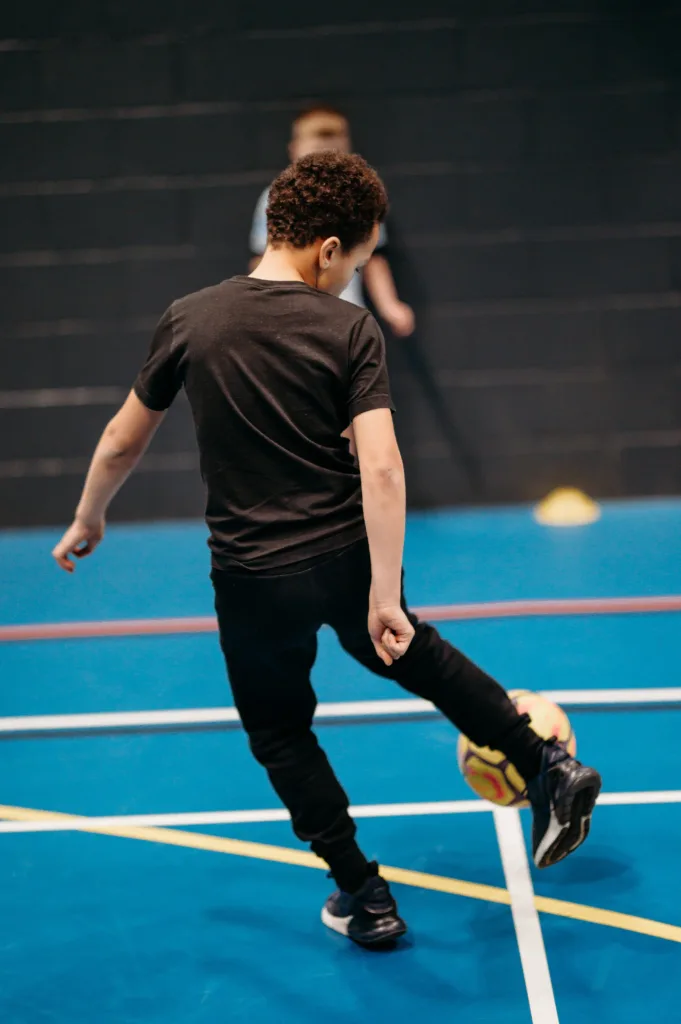 Young boy playing indoor football