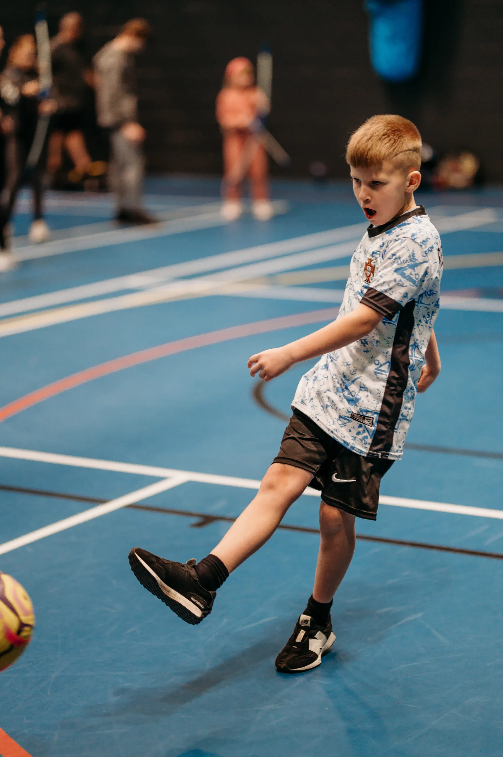 Young child kicking a football